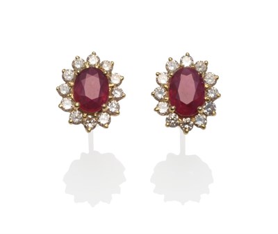 Lot 256 - A Pair of Ruby and Diamond Cluster Earrings, an oval mixed cut ruby within a border of round...