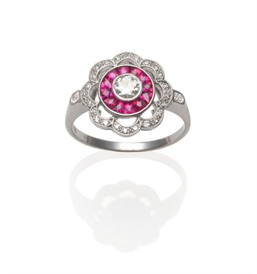 Lot 263 - An Art Deco Style Ruby and Diamond Cluster Ring, a round brilliant cut diamond within a border...