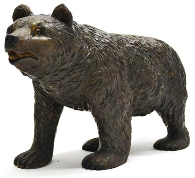 Lot 2135 - A Swiss (Brienz) Carved and Stained Linden Wood Model of a Bear, circa 1900, walking on all...