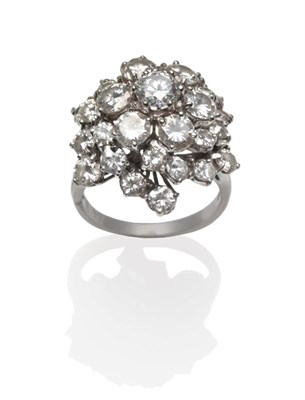 Lot 275 - A Diamond Cluster Ring, round brilliant cut diamonds in a central cluster, with six radial rows...