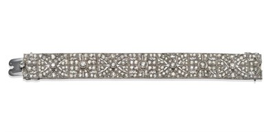 Lot 276 - An Art Deco Diamond Bracelet, set with eight collet set old cut diamonds, within articulated...