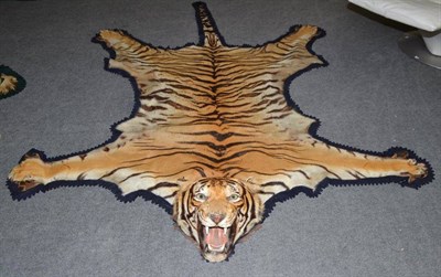 Lot 2177 - Tiger (Panthera tigris), circa 1930, by Rowland Ward, skin rug with head mount, 260cm long,...