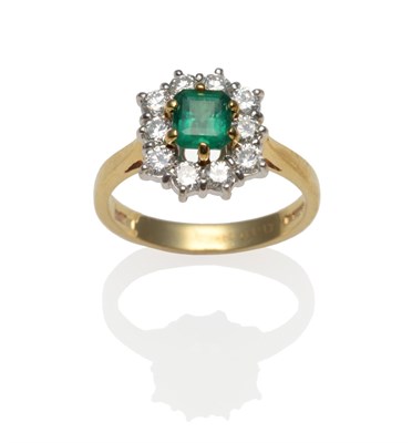 Lot 278 - An 18 Carat Gold Emerald and Diamond Cluster Ring, the emerald-cut emerald within a border of...