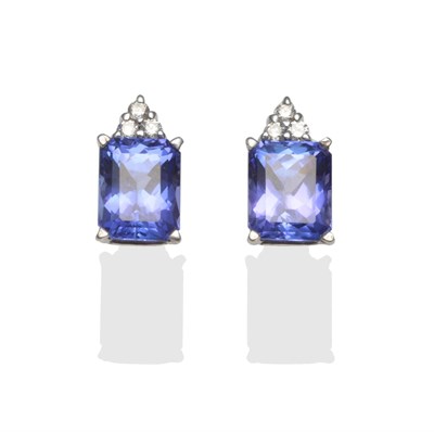 Lot 289 - A Pair of Tanzanite and Diamond Earrings, each stud comprises a radiant cut tanzanite surmounted by