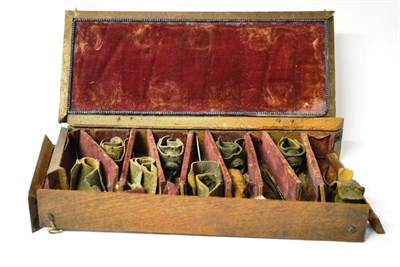 Lot 1064 - A Cased Set of Nine 19th Century Steel Cockfighting Spurs, eight with leather straps, in a...