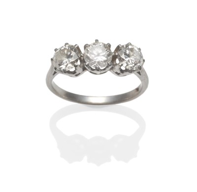 Lot 298 - A Diamond Three Stone Ring, the brilliant cut diamonds in white claw settings to a tapered shoulder