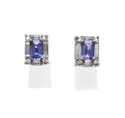 Lot 300 - A Pair of Tanzanite and Diamond Cluster Earrings, an emerald-cut tanzanite with a baguette cut...