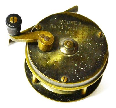 Lot 1201 - A Moore's 2 1/2"; Brass 'Rapid Trout Reel 1912', multiplying reel with black handle on brass...