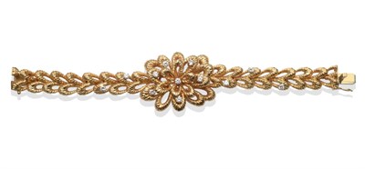 Lot 310 - An 18 Carat Gold Diamond Set Bracelet, composed of a textured openwork flower head, the bracelet of