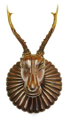 Lot 1226 - A Continental Carved Wood Head of a Roe Deer, with real 6 point perled antlers, on a gadrooned wall