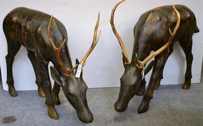 Lot 1231 - A Pair of Carved Wood and Painted Models of Grazing Deer, late 20th century, each with real...