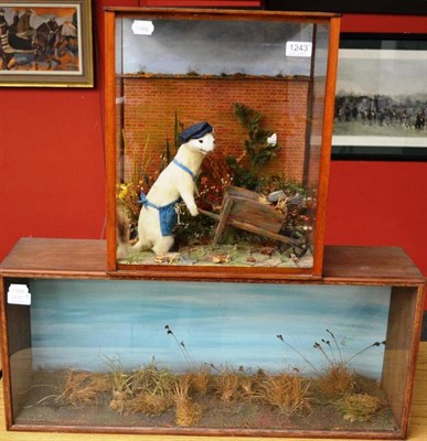 Lot 1243 - Taxidermy Fishing Squirrel, circa 1960, wearing a hat and seated on the bank of a river beneath...