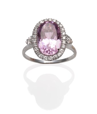 Lot 318 - An 18 Carat White Gold Kunzite and Diamond Cluster Ring, an oval cut kunzite within a border of...