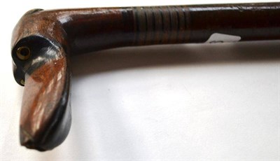 Lot 1296 - A Mahogany and Laminated Wood Walking Stick, circa 1925, the mahogany handle as the head of a...