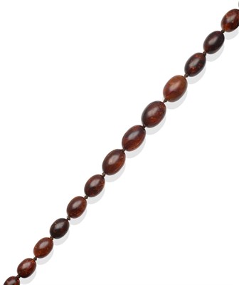 Lot 324 - An Amber Necklace, of twenty-seven graduated olive shaped brownish coloured beads, accompanied by A