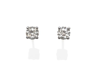 Lot 336 - A Pair of 18 Carat White Gold Diamond Solitaire Stud Earrings, the round brilliant cut diamonds...