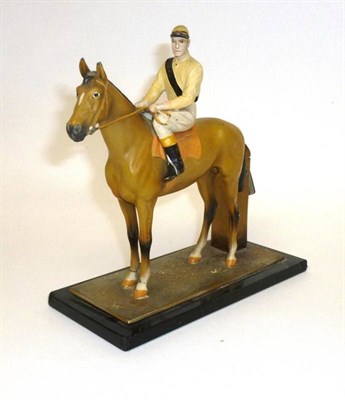 Lot 77 - A Painted Spelter Horse and Jockey Strike-lite Table Lighter, with wand, on a black glass base