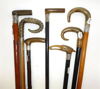 Lot 120 - Seven Horn Handled Walking Sticks, one carved with a birds head, five with silver collars,...