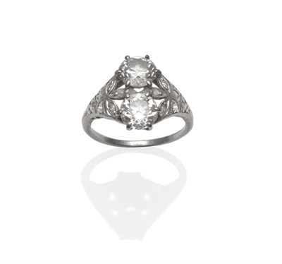 Lot 364 - An Early 20th Century Diamond Two Stone Ring, two old cut diamonds set vertically, to foliate...