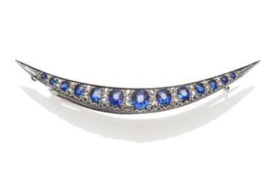 Lot 384 - An Early 20th Century Sapphire and Diamond Crescent Brooch, the graduated oval mixed cut...