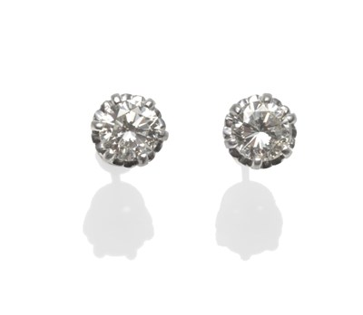 Lot 386 - A Pair of Diamond Solitaire Stud Earrings, the round brilliant cut diamonds in white claw settings