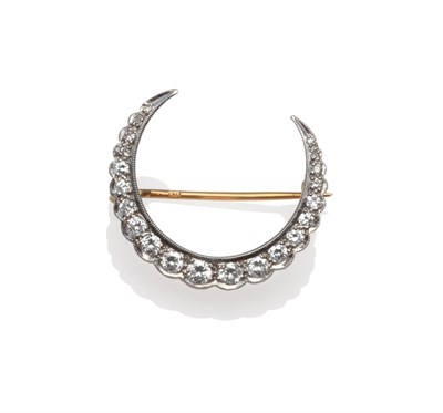 Lot 387 - An 18 Carat Gold Diamond Crescent Brooch, graduated eight-cut and round brilliant cut diamonds...