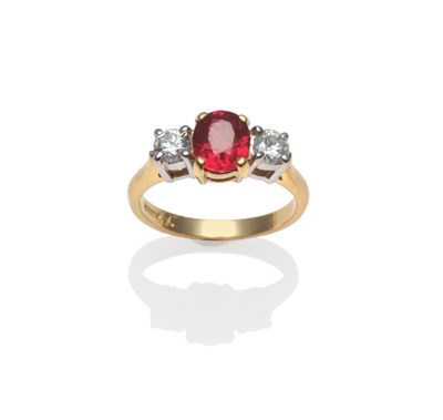 Lot 390 - An 18 Carat Gold Ruby and Diamond Three Stone Ring, the oval mixed cut ruby with a round...