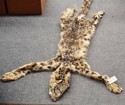 Lot 439 - A Snow Leopard Skin (Panthera uncia), circa 1930, stitched at the belly, 233cm long nose-to-tail