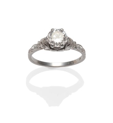 Lot 398 - A Diamond Solitaire Ring, a round brilliant cut diamond in a white claw setting, to fancy shoulders