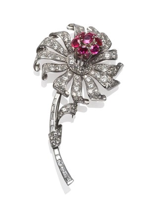 Lot 399 - A Ruby and Diamond Flower Brooch, set with oval cut rubies, round brilliant cut, baguette cut...