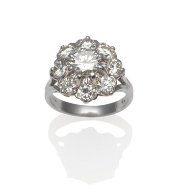 Lot 400 - A Diamond Cluster Ring, a round brilliant cut diamond within a border of eight round brilliant...