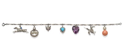 Lot 410 - A Charm Bracelet, the white fancy link bracelet hung with seven charms, some diamond set, including