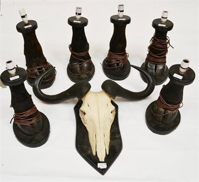 Lot 118 - Brindled Gnu (Connachaetes tauranus), horns on skull, on wood shield; and Six Buffalo Foot Lamp...