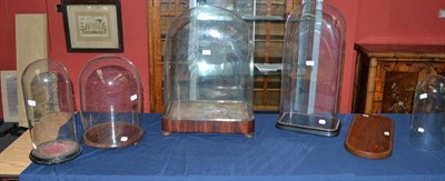 Lot 203 - A Victorian Glass Dome on Mahogany Plinth, with button feet, 63cm high; Another, on ebonised...