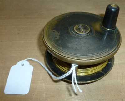 Lot 113 - A Malloch 3inch Brass Trout Reel, with fat black handle, logo enclosed within a shield 'P.D.Malloch