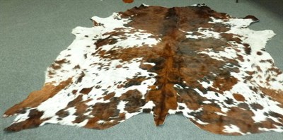 Lot 254 - Two Cattle Hide Rugs, one attractively brindled, the other brown and white, 225cm and 200cm...