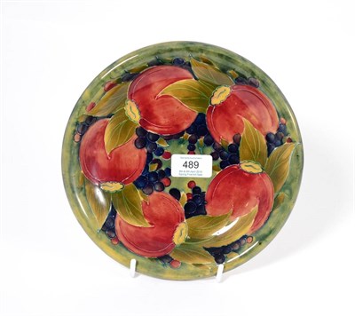 Lot 489 - A William Moorcroft Pomegranate Pattern Plate, circa 1912-14, on a green mottled ground, green...