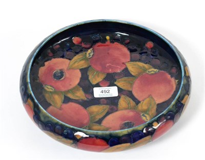 Lot 492 - A William Moorcroft Pomegranate Pattern Pedestal Bowl, on a blue ground, on a pewter base,...