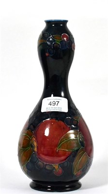 Lot 497 - A William Moorcroft Pomegranate Pattern Bottle Vase, on a blue ground, impressed factory marks...