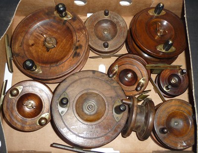 Lot 157 - Eight Wooden Nottingham Reels, various sizes, with brass star and strap backs, one by Allcock,...