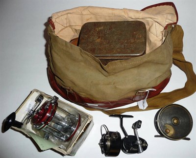 Lot 196 - A Leather Trimmed Canvas Tackle Bag, containing a 3 1/2in ebonite and brass platewind reel, two...