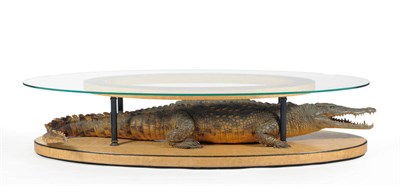 Lot 187 - An Art Deco Crocodile Mounted Satinwood, Bronze and Glass Oval Coffee Table, circa 1930, the...