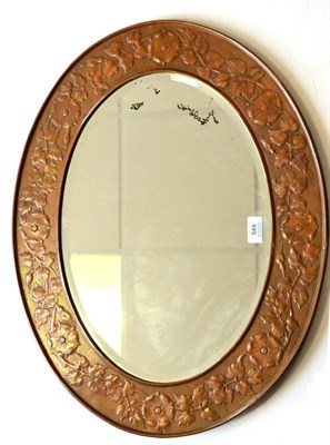 Lot 549 - A Keswick School of Industrial Arts Oval Copper Framed Mirror, with rose and foliage...