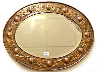 Lot 550 - A Keswick School of Industrial Arts Oval Copper Framed Mirror, with repousse foliate and...