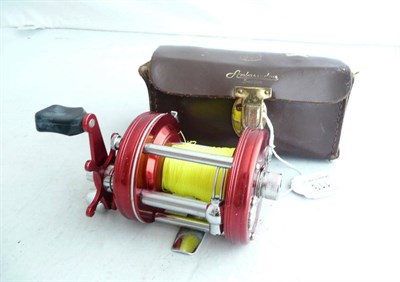 Lot 113 - An Abu Ambassadeur No.6000 Multiplying Reel, with metallic red finish, chrome fittings and...