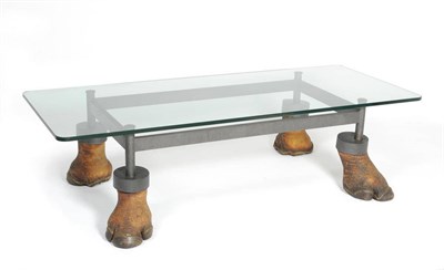 Lot 144 - A Rhinoceros Foot Mounted Coffee Table, the rectangular frame supported by a rhino foot at each...