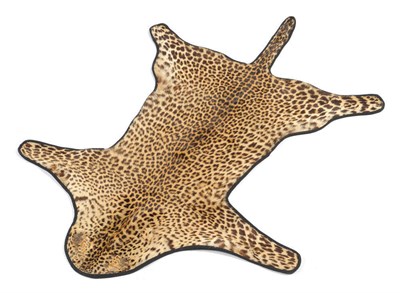 Lot 219 - Leopard (Panthera pardus), circa 1961, flat skin rug, 134.5cm long, backed onto black felt,...