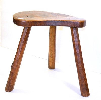 Lot 594 - A Robert  "Mouseman " Thompson Oak Cow Stool, circa 1930/40, the kidney shaped seat on three...