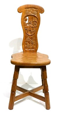 Lot 627 - A Sid Pollard of Thirsk Oak Spinning Chair, the shaped back carved with a panel depicting a...