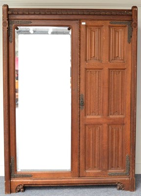 Lot 633 - A Victorian Oak Mirror Door Linen Press, by Gillows, the crenellated cornice above a panelled linen